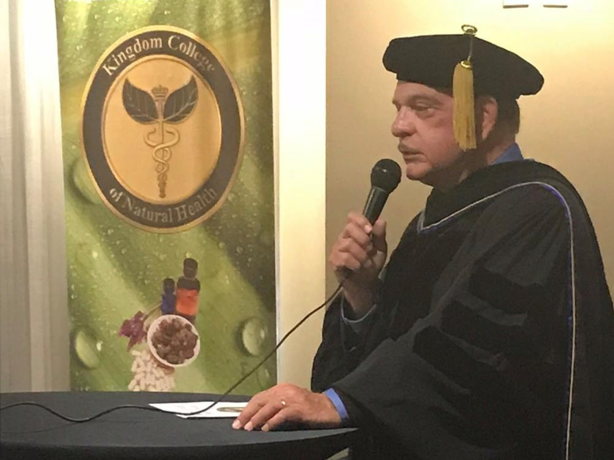 Dr. Harbuck delivering graduation speech at podium
